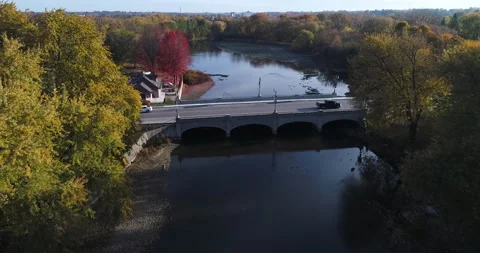 Aerial Over River Pass Tree Shorelines And Above Bridge With Traffic Crossing Stock-Footage 200802084