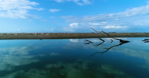 Aerial Over River Tide Pool, Reflecting The Clouds And Blue Sky In The Waters Stock Footage 134599311