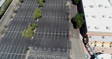 Aerial Over Rows Of Empty Parking Spaces As Covid-19 Pandemic Closes Stores Stock Footage 127811954