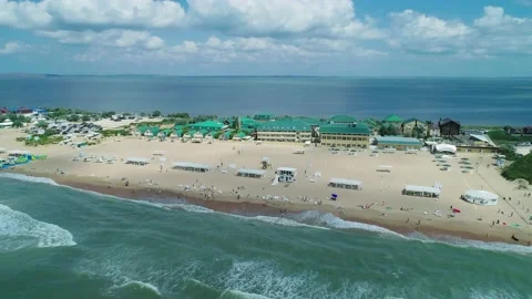 Aerial over the sandy beach with many people and azure water on a summer day Stock-Footage 219774116