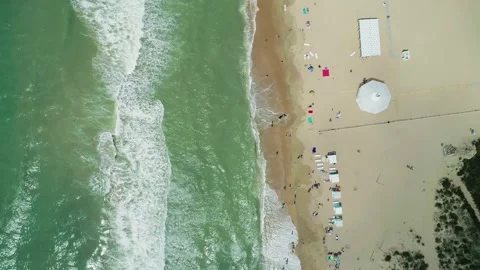 Aerial over the sandy beach with many people and azure water on a sunny summer Video stock 219774221