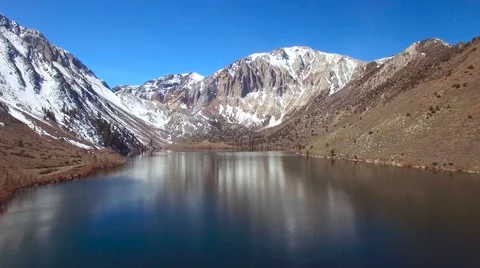 An aerial over the Sierra Nevada mountains reveals an attractive lake. Stock Footage