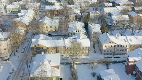 Aerial over small and old snowy suburb neighborhood in Europe Stock Footage 101856016