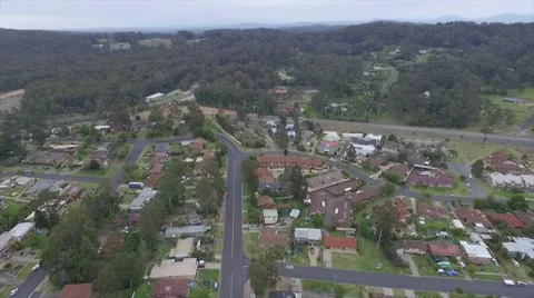 AERIAL OVER SUBURBS AND FOREST Stock Footage