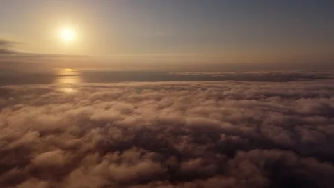 Aerial Over Sunrise Cloud Deck, Sun High at Left With Water Reflection 库存影片 345091047