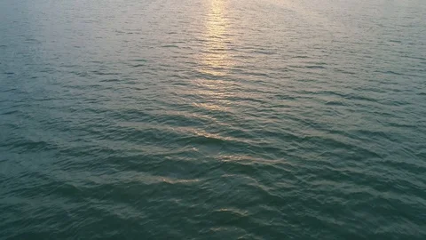 Aerial over water surface on the sunset, sun track sparks Stock Footage 100405785