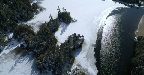 Aerial Over Wilderness Pine Winter Lake Towards Snow Covered Ice Till All White Stock Footage 162136599