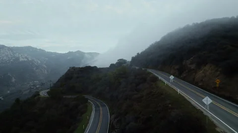 Aerial over winding road with rolling clouds in Malibu mountains Video stock 168214871