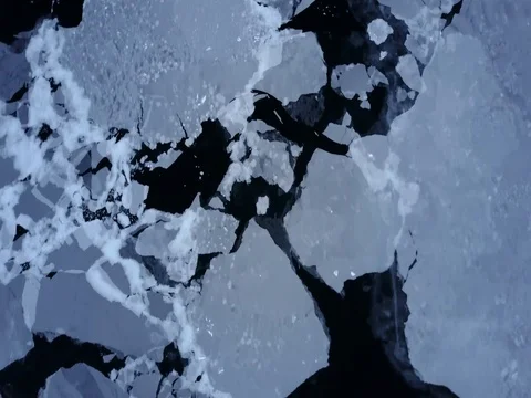Aerial overhead of arctic circle glacial ice frozen in the ocean in winter Stock Footage