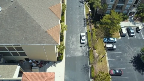 Aerial Overhead Drone View White Car Driving Streets in Orlando Florida Stock Footage 103493391