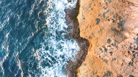 Aerial overhead flying over waves at sunset Stock Footage 101021971