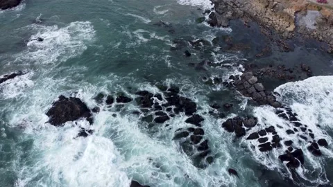 Aerial overhead shot of waves hitting rocks on the coast of baja california Stock Footage 233233164
