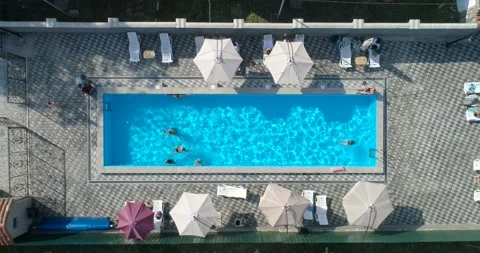 Aerial overhead slow motion shot on swimming pool and swimming people. 4K Stock Footage 155334229