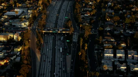 Aerial overhead sunset view of rush hour on city freeways Los Angeles Stock Footage 64786481