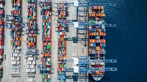 Aerial overhead time lapse view of large container cargo ship being unloaded Stock Footage 310832443