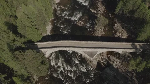 Aerial overhead view of Bridge of Dee old stone structure crossing river and Stock-Footage 251045236