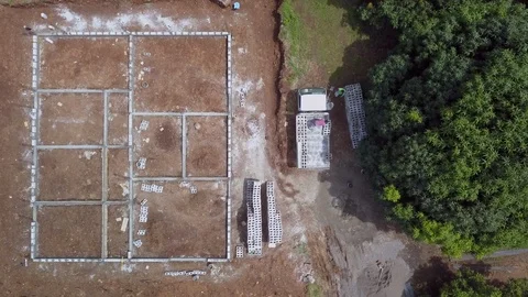 Aerial overhead view of men unloading truck at Guatemalan construction site Stock Footage 122952320