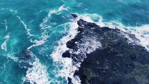 Aerial Overhead View of Ocean Waves Crashing on Rocky Shore Stock Footage 345101945
