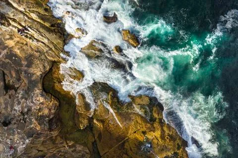 Aerial, overhead view of waves and a rocky shoreline Stock Photos