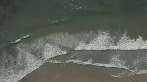 Aerial overhead of waves rolling onto the shore Stock Footage 157133510
