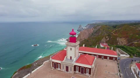 Aerial overpassing the lighthouse revealing the cliffs of Cabo da Roca Stock Footage 330898100