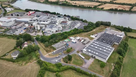 Aerial overview of modern meat processing plant next to the River Suir at Stock Footage 345010247