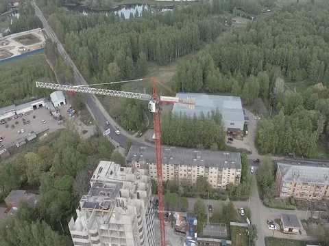 Aerial overview of tower crane in the construction of slabs homes Stock Footage 76102994