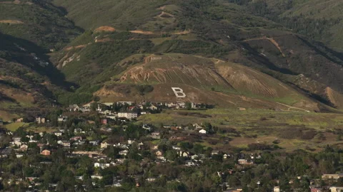 Aerial of painted B on mountainside in Bountiful Utah with neighborhoods 스톡 동영상 335720411