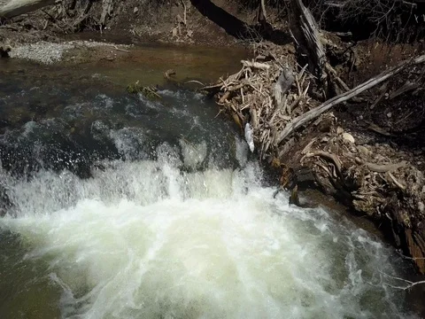 Aerial pan across mountain river stream waterfall 4K Stock Footage