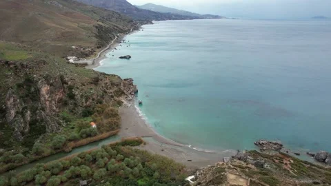 Aerial pan along the cliffs and coastline at Preveli, south Crete Stock Footage 346744860