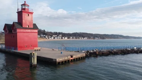 Aerial Pan of Big Red Lighthouse by the water Stock Footage