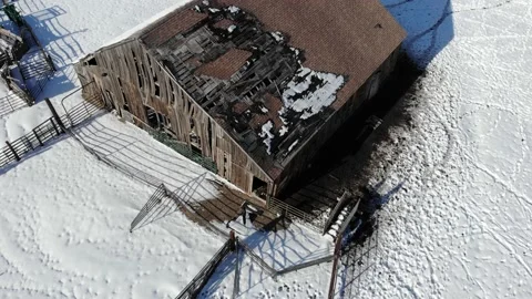 Aerial Pan of Broken Down Barn with Snow - Drone Stock Footage 147912138