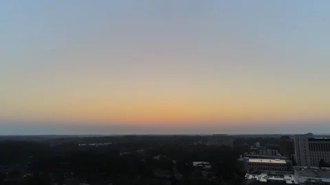 Aerial Pan Down from Blue Sky with Moon to Foggy Sunrise over City Durham NC 動画素材 97363941