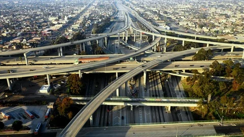 Aerial Pan Down-Bustling Multi-Layered Bridges With Town Behind During Day in Stock Footage 107183541