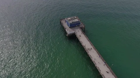 Aerial pan down over a long rectangular pier Stock Footage 157137587