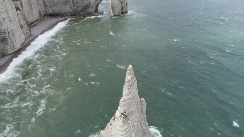 Aerial pan down view of Étretat chalk cliff called L'Aiguille or Needle 4k Stock Footage 126370463