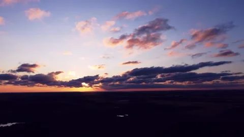 Aerial pan of dramatic summer sunset over farmland Stock Footage 176585723