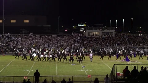 Aerial pan of high school band performing Video stock 70081653