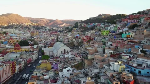 Aerial pan of hillsides full of houses at sunset Stock Footage