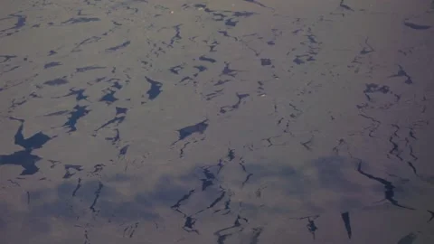 Aerial: pan from ice on Davis Strait to sunset flying over Greenland Stockbeeldmateriaal 235650422