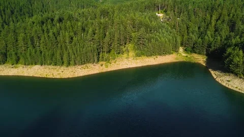 Aerial pan left over pristine mountain lake surrounded by green hills Serbia Stock Footage 342241887