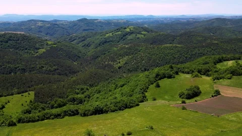 Aerial pan left over vibrant green mountain range and rolling hills Serbia Stock Footage 342241596