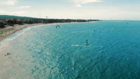Aerial Pan Left to Right of Para surfing and Windsurfing in the Beach of Stock Footage 102765468