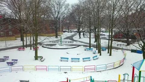 Aerial Pan Left View of an Inner City Park During a Snow Storm - Par Video stock 149345005