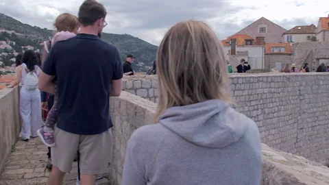 Aerial pan of Old Town rooftops and Dubrovnik City Wall, Croatia Video stock 283181149