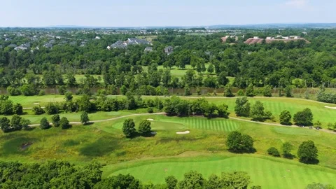 Aerial Pan Over Lush Golf Course and Suburban Neighborhood Stock Footage 346188714