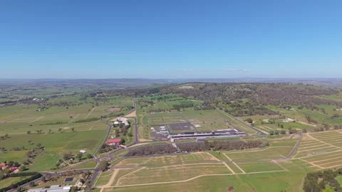 Aerial pan over Mount Panorama Circuit and Bathurst countryside NSW Stock Footage 334927505