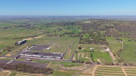 Aerial pan over Mount Panorama Circuit and Bathurst countryside NSW Stock-Footage 334927593