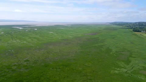 Aerial pan over River Dee estuary wetlands at Parkgate, Wirral, England Stock Footage 328266720