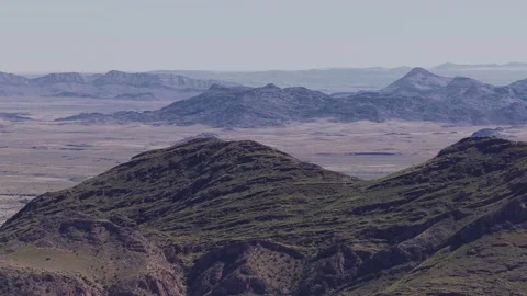 Aerial pan over striated ridges and desert plains in Namibia Stock Footage 341440779